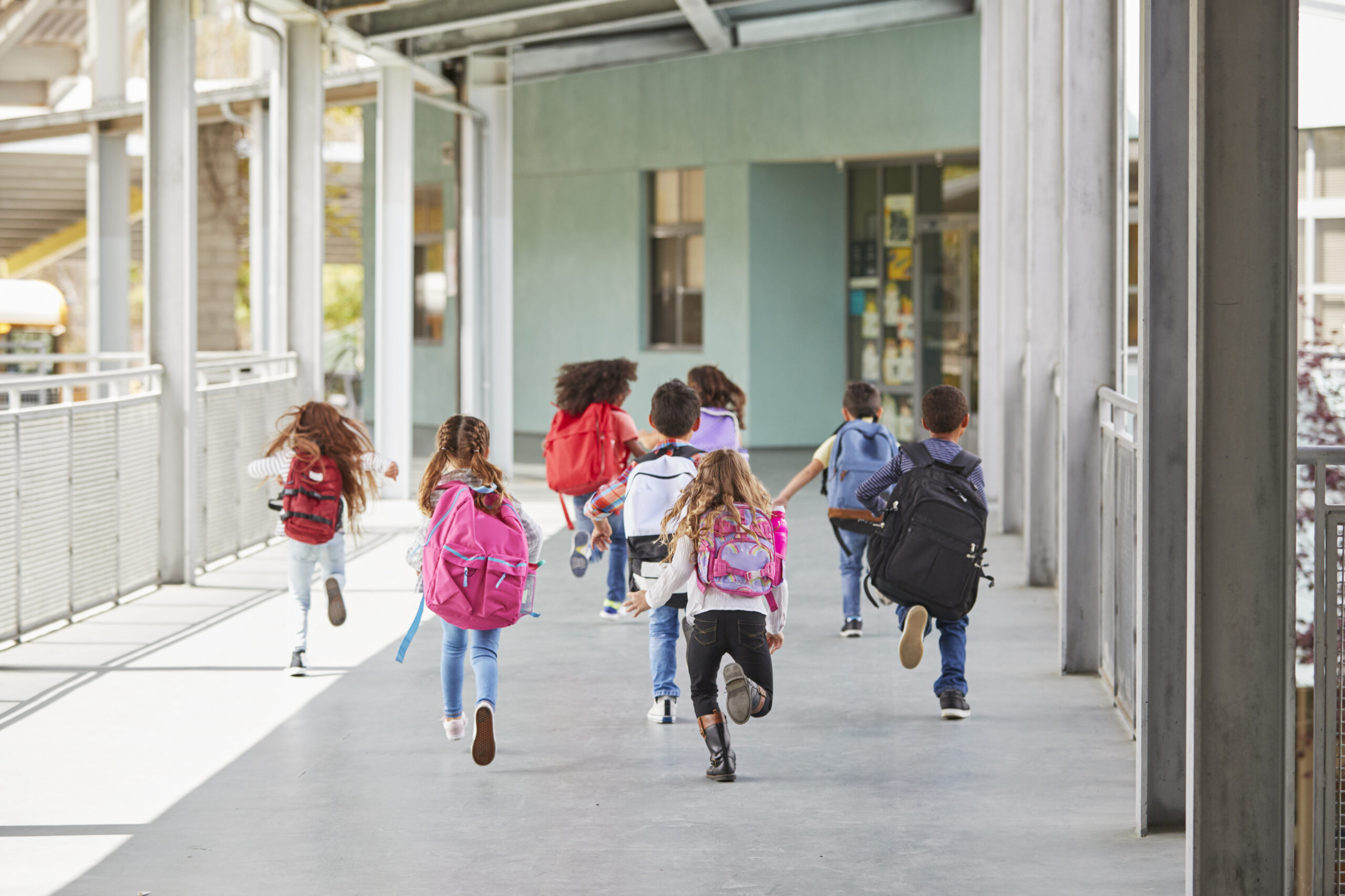 elementary kids running down a school hallway