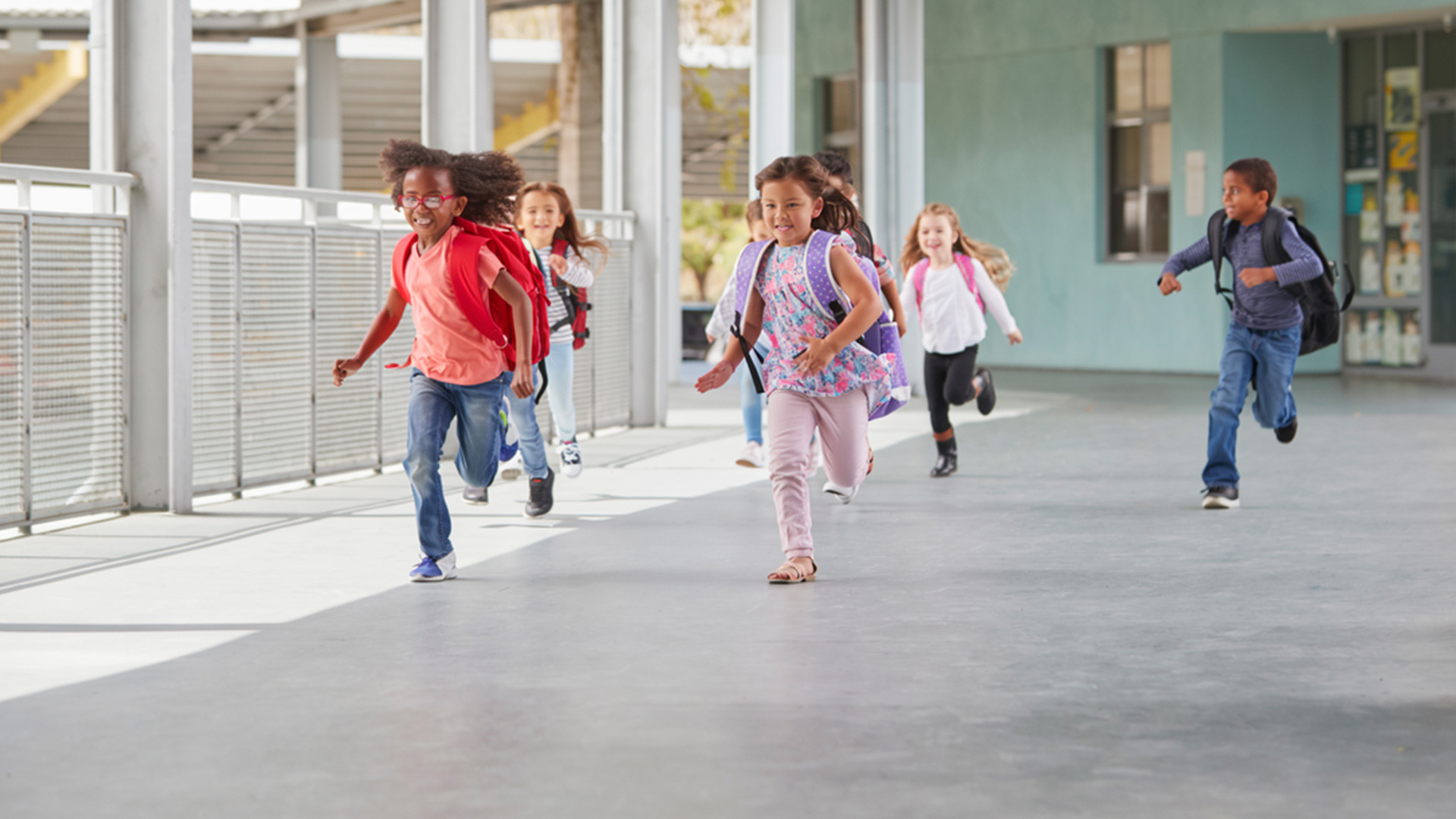 elementary kids running down a school hallway